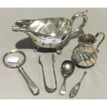 A silver magnifying glass, a silver caddy spoon,