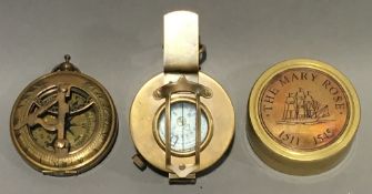 Three brass compasses