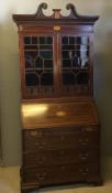 An Edwardian Georgian style inlaid mahogany bureau bookcase