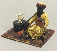 A cold painted bronze model of a smoking Arab