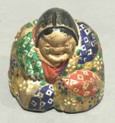 A painted wooden netsuke