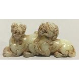 A Chinese jade carving formed as two dogs-of-fo
