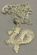 A Chinese silver dragon pendant on chain