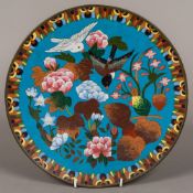 A cloisonne plate decorated with birds amongst foliage