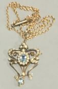 An Edwardian Art Nouveau gold seed pearl pendant on an unmarked chain