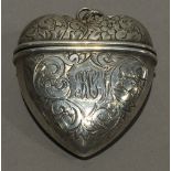 A silver vesta in the form of a heart