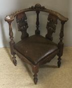 A 19th century corner chair with carved cherub decoration