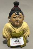 A small Japanese carved wooden figure