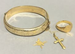 A gold plated bangle, a gold signet ring,