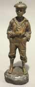 A patinated bronze figure of a young boy