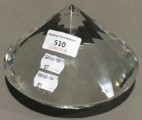 A paperweight in the form of a diamond