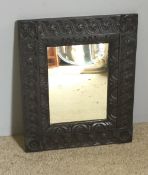 A carved oak mirror