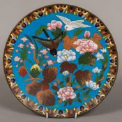 A cloisonne plate decorated with birds amongst foliage