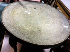 An Eastern brass topped coffee table