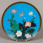 A cloisonne plate decorated with birds and foliage