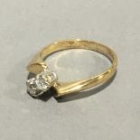 A 9 ct gold diamond set two stone crossover ring