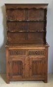 An oak linen fold dresser with rack