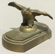 A bronze owl formed letter clip