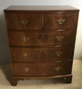 A 19th century style walnut bow front chest of drawers