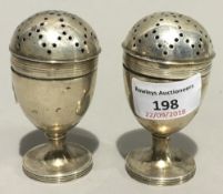 A pair of Victorian silver pepper pots