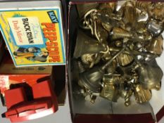 A collection of brass bells, a cased portable Penetrator, a View Master with viewing cards,