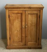 A small Victorian pine two door cupboard