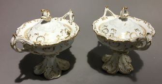 A pair of 19th century porcelain twin handled comports and covers