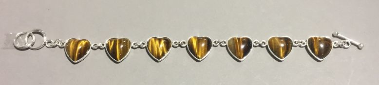 A silver and tigers eye heart shaped bracelet