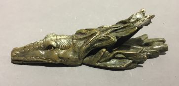 A bronze letter clip in the form of a crocodile