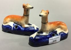 A pair of Victorian Staffordshire greyhound inkwells