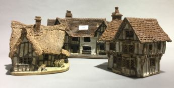 Three ceramic model cottages