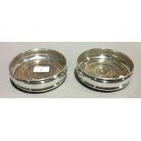 A pair of silver bottle coasters