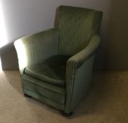 An early 20th century green upholstered tub armchair