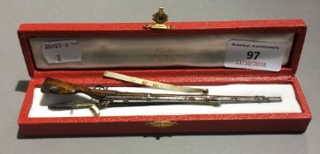 A miniature officer's sword and a miniature flintlock musket