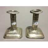 A silver mirror and a pair of silver dwarf candlesticks