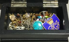 A wooden box of various jewellery