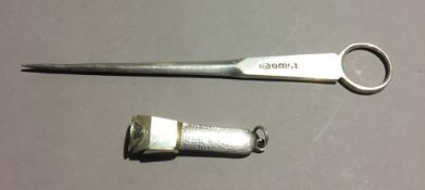A silver cigar cutter and a silver plated meat skewer