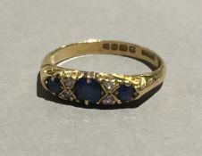 An 18 ct gold diamond and sapphire ring (3.