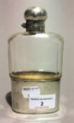 A silver mounted cut glass hip flask