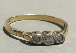 An 18 ct gold and three stone diamond ring (2 grammes all in)