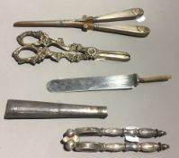 A pair of silver handled glove stretchers, together with a pair of plated grape shears,