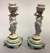 A pair of bisque fired figural candlesticks, made by Jeane Gille of Rue De Paradis, Poissonnieere,