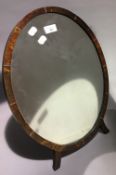 A tortoiseshell mounted oval toilet mirror