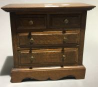 A miniature oak chest of drawers