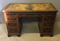 An Edwardian inlaid mahogany pedestal desk