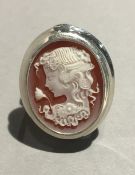 A silver dress cameo ring