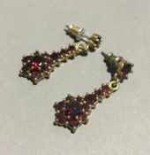 A pair of garnet set pendant earrings