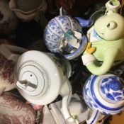 A large collection of decorative teapots