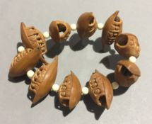 A Chinese carved nut bracelet