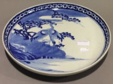 A Chinese blue and white charger decorated with two cranes